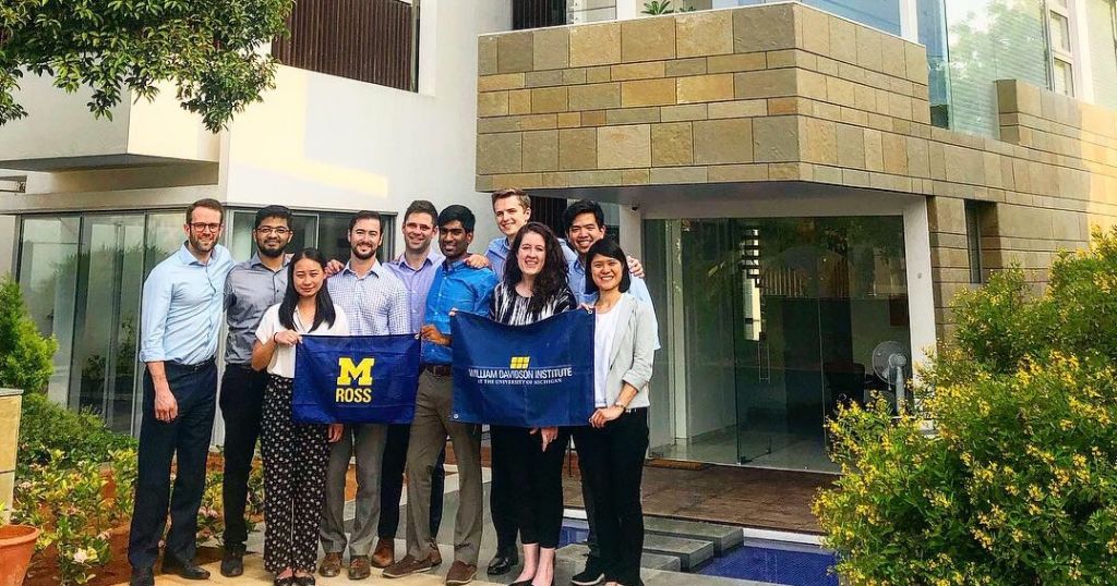 Participants of WDI MAP IIF Fund project hold Ross and WDI flags on location
