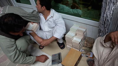 Stacks of cash sit opening in teh Hawala market