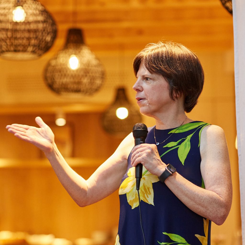 Amy Gillett speaking at dinner gathering of NGO participants