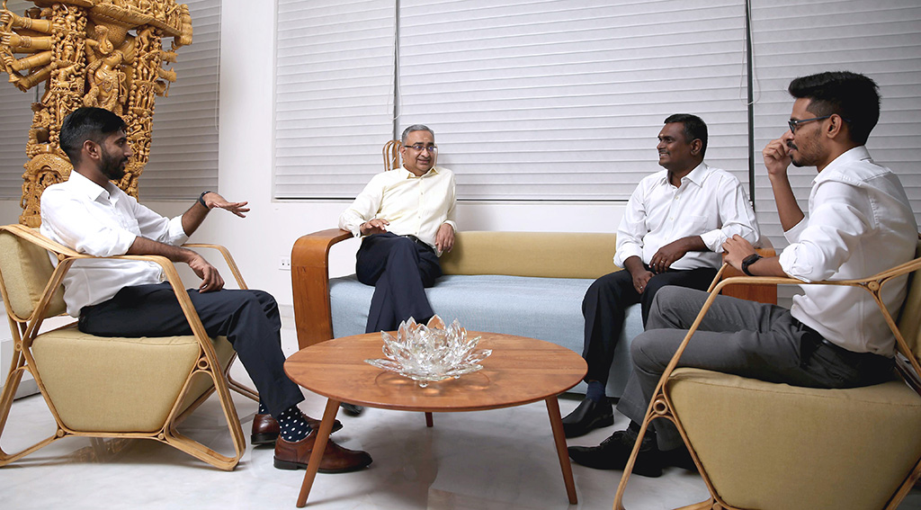 Indian men sitting in a room talking